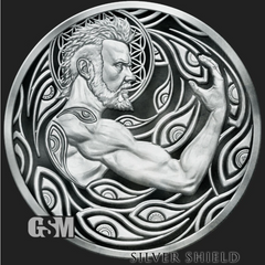 A circular silver-toned medallion or coin featuring a muscular bearded male figure in profile, surrounded by ornate flowing wave-like patterns. The piece is shown on a dark background with a visible 'GSM' mark at lower left and the text 'SILVER SHIELD' at lower right.